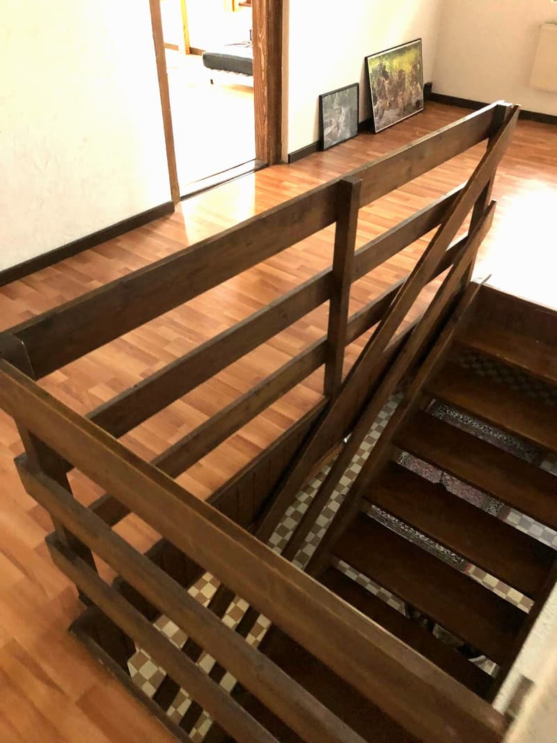 wooden staircase, wooden floor, checkered floor, paintings on the wall