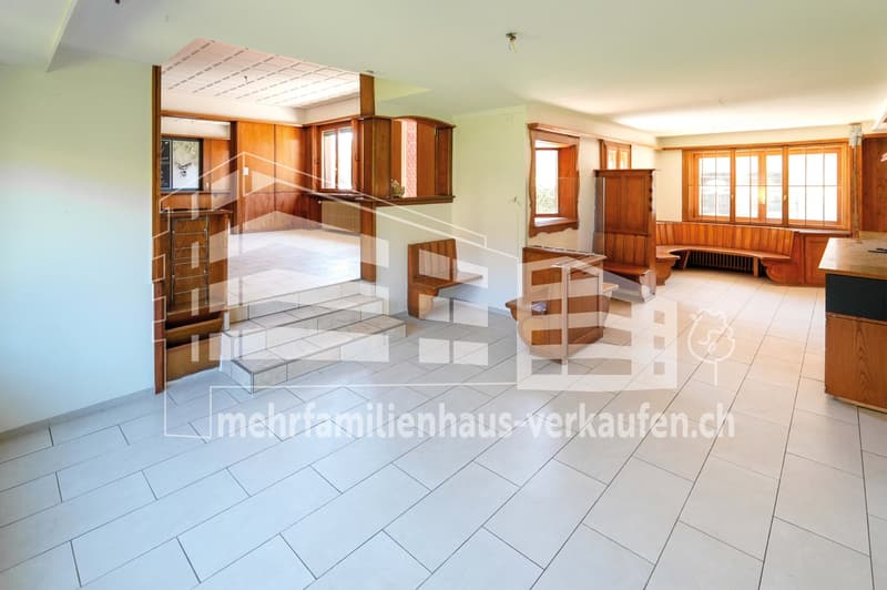 large open space, white tiles, wooden benches, wooden cabinets, windows, radiator