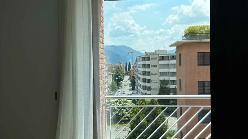 balcony, white curtains, glass door, city view