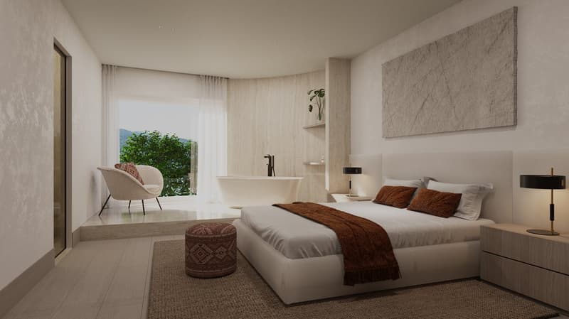 bed with brown blanket, beige walls, beige rug, bathtub with shower, window, decorative chair