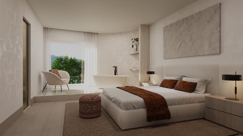 A bedroom with a large bed, a bathtub, and a balcony with a view of greenery.