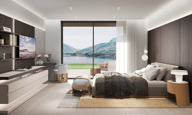 A bedroom with a bed, two bedside tables, a carpet, a TV, a desk, and a glass wall overlooking a landscape.
