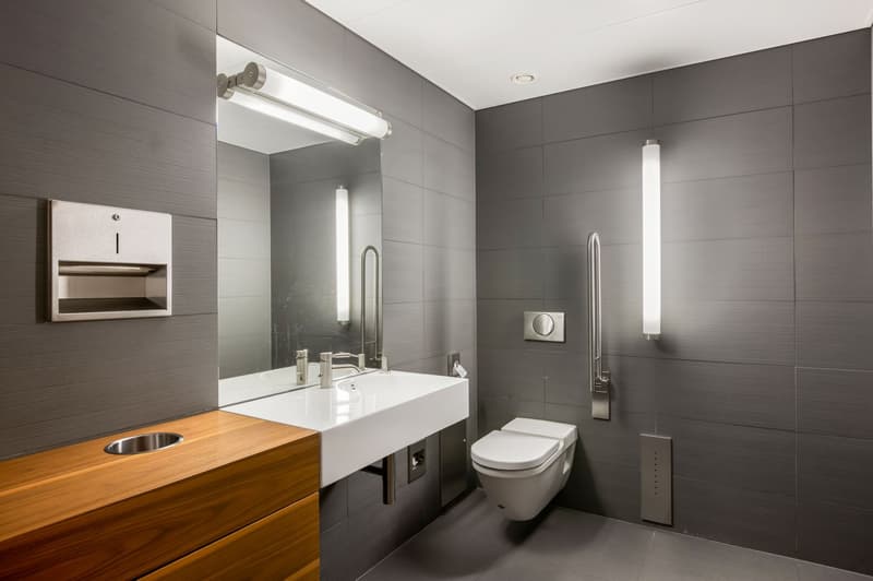 Contemporary design, gray walls, white sink, modern fixtures, wall-mounted toilet, integrated lighting