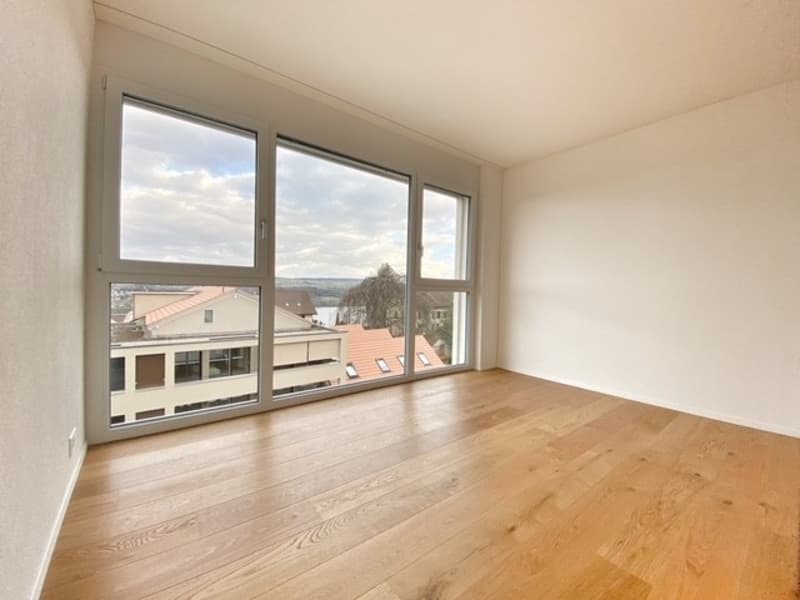 empty room, hardwood floors, large windows, white walls, view of the outside