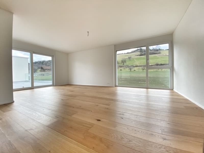 empty room, wooden floor, white walls, large windows, view of the outside