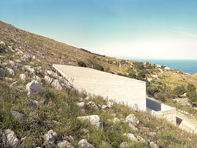 Contemporary building on a hillside with a stunning view of the sea