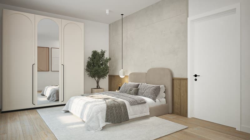 A well-lit bedroom featuring a large bed, full-length mirrored wardrobe, small potted tree, and an open-plan layout with carpeted flooring.