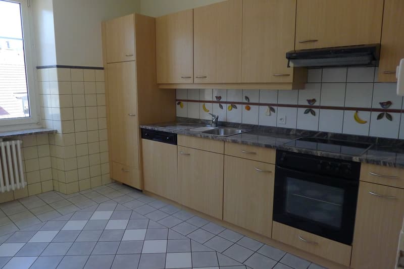 kitchen with oven, stove, dishwasher, tiles, cabinet, countertop, window, heater