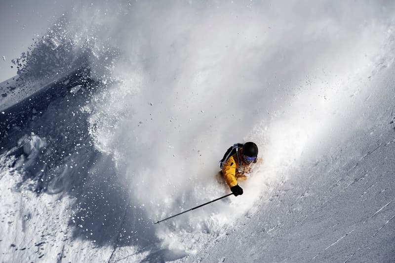 Person skiing down a snowy mountain