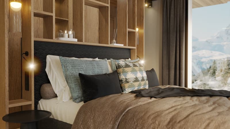 spacious bed, dark colored comforter, various pillows, built-in nightstand, mounted wall lights, large window with snowy mountain view