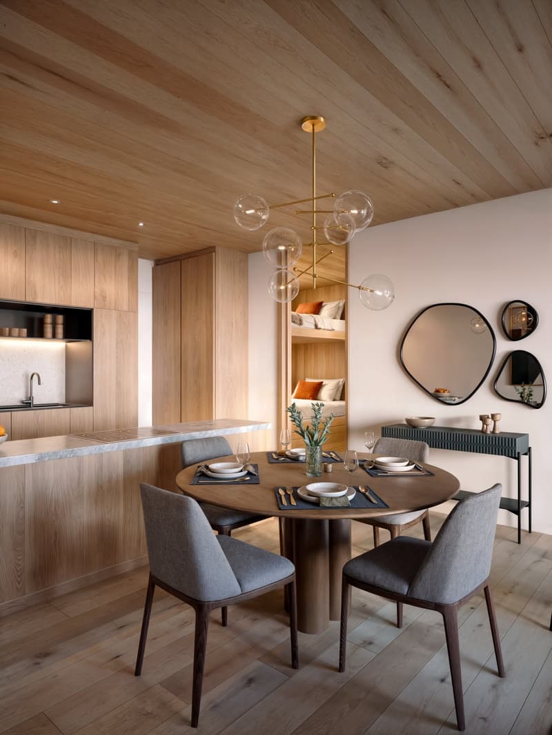 Dining area with a round wooden table, 4 chairs, a chandelier, a kitchen with a sink, a counter, and a wooden cabinet, a mirror, and a small bedroom