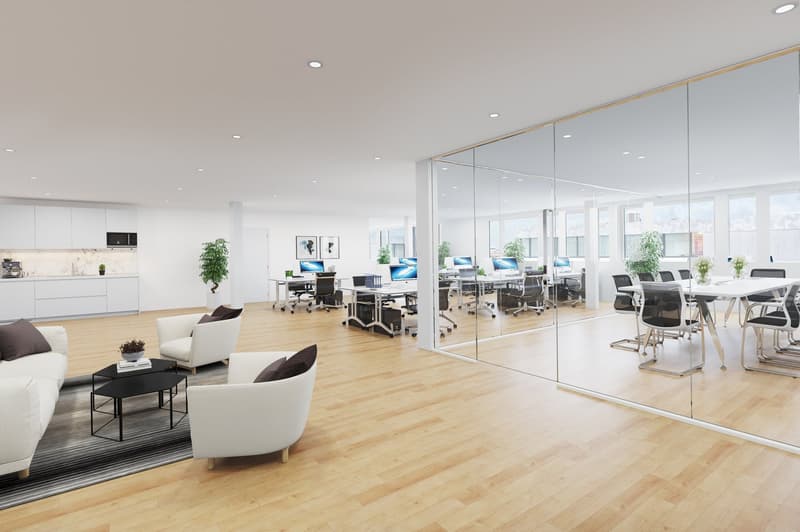 modern office with wooden floors, glass walls, multiple workstations, desks, monitors, a kitchen, couches, table, and chairs