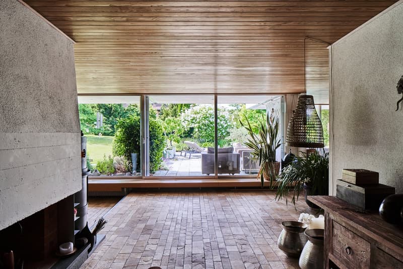 Wooden floor, wooden ceiling, brick fireplace, large windows, sliding glass doors to the terrace