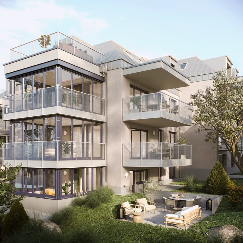 Multi-story building, gray exterior, large glass windows, multiple balconies, outdoor patio with furniture