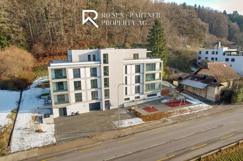 New building with balcony and garages