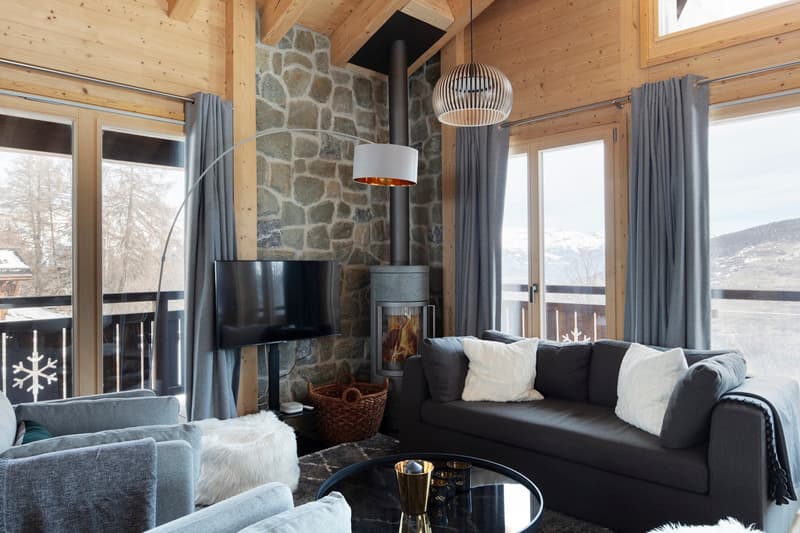 wooden walls, stone wall, fireplace, large windows, balcony, sofa, coffee table, TV