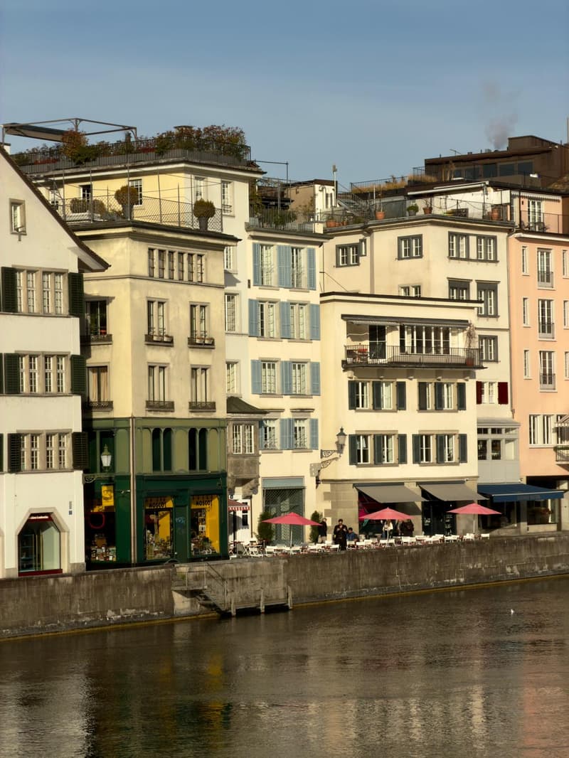 multi-story buildings, balconies, awnings, river view