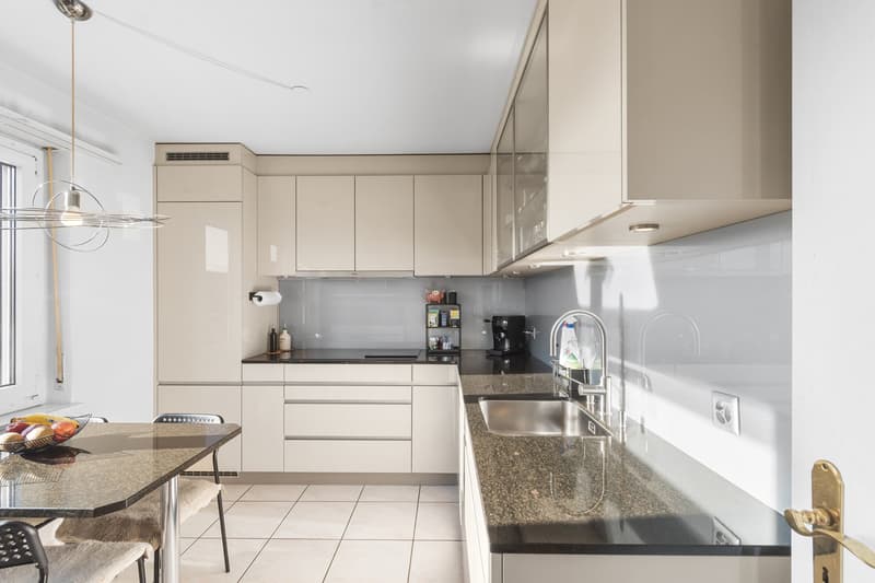 white tiled floor, modern white cabinetry, granite countertop, stainless steel sink, dishwasher, washing machine, modern fixtures, window
