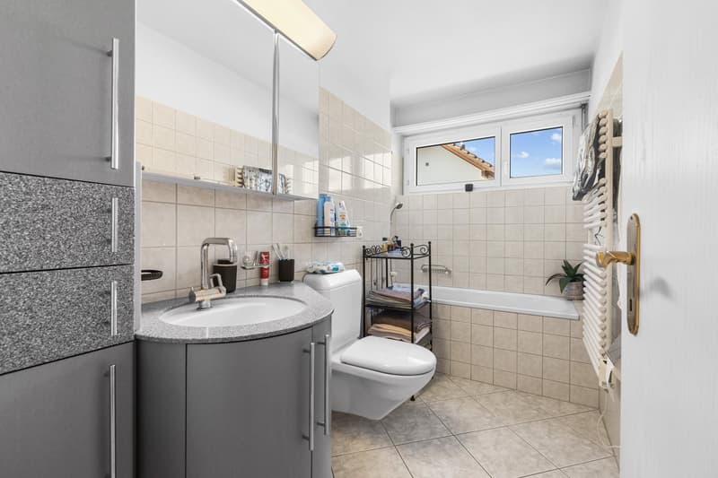 modern white and grey bathroom, sink, toilet, bathtub, window