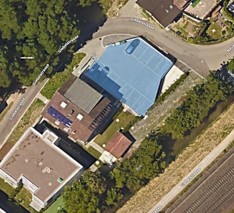 buildings with parking area, swimming pool, solar panels on the roof