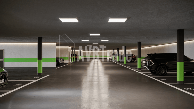 Empty car park, lined parking spaces, white parking lines, green columns, ceiling lamps