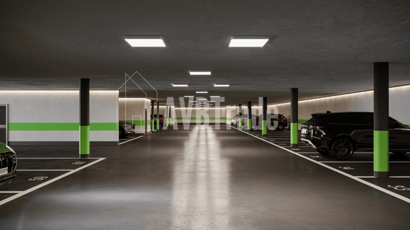 Empty car park, lined parking spaces, white parking lines, green columns, ceiling lamps