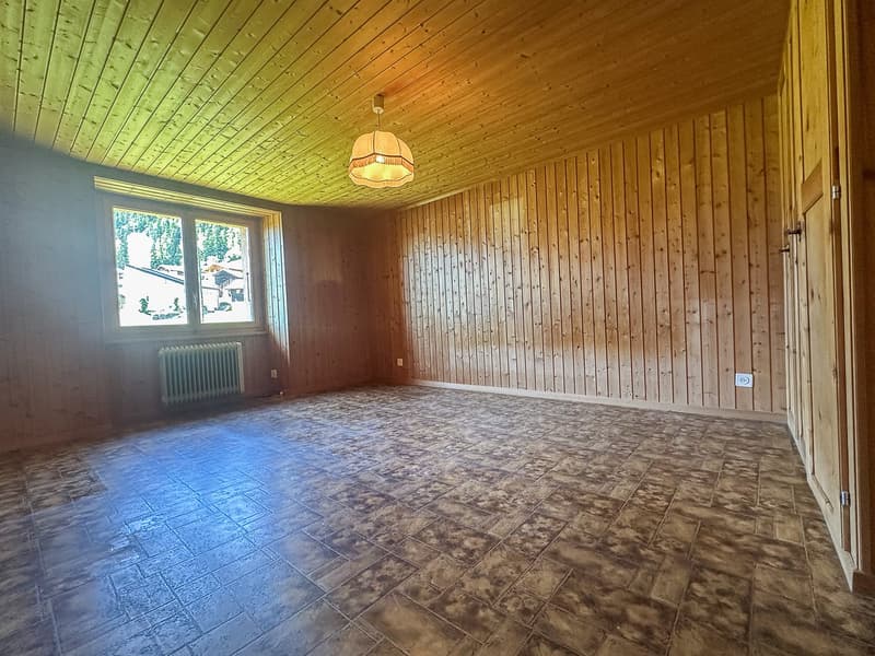 empty room, wooden walls, radiator, tiled floor, power outlet
