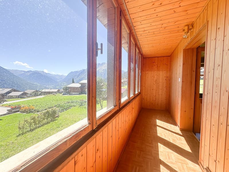 wooden walls, parquet floor, large windows overlooking mountains, terrace