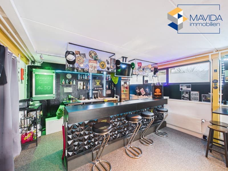 Modern bar counter, stools, shelves with bottles, blackboard, TV, lighting, various items, radiator