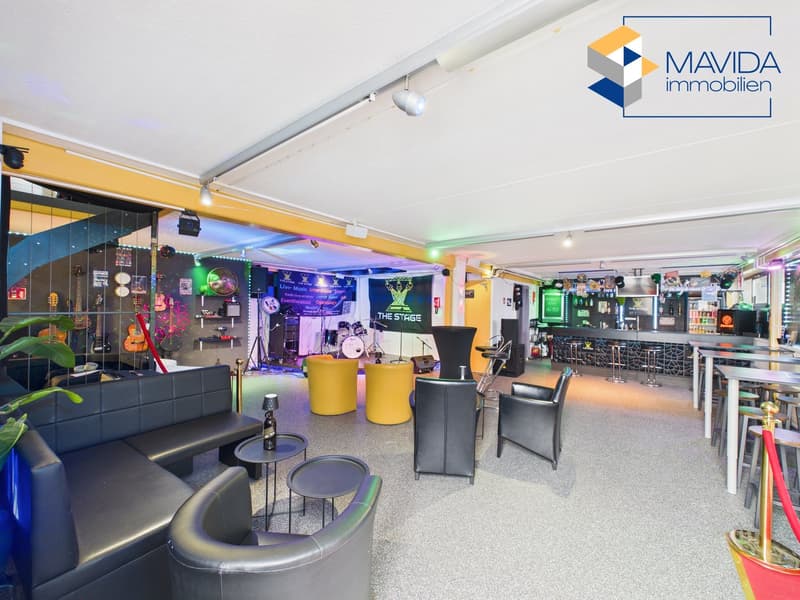 Lounging area, tables, couches, stage, guitars, lights, lamps, bar counter, bottles