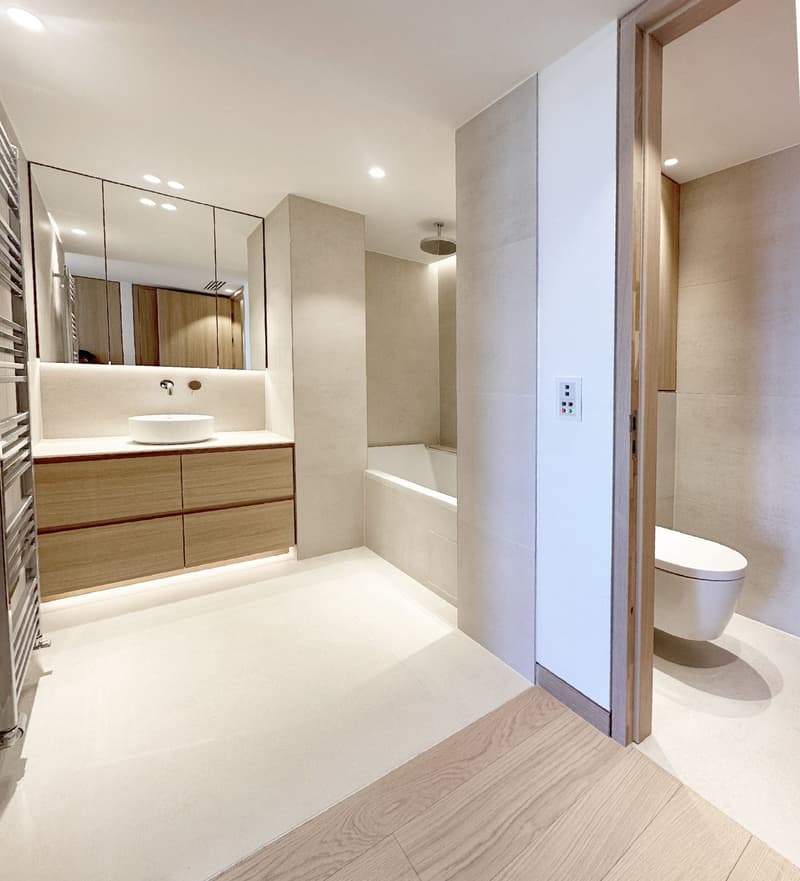 modern bathroom, white tiles, wooden vanity, bathtub, shower, toilet, mirror
