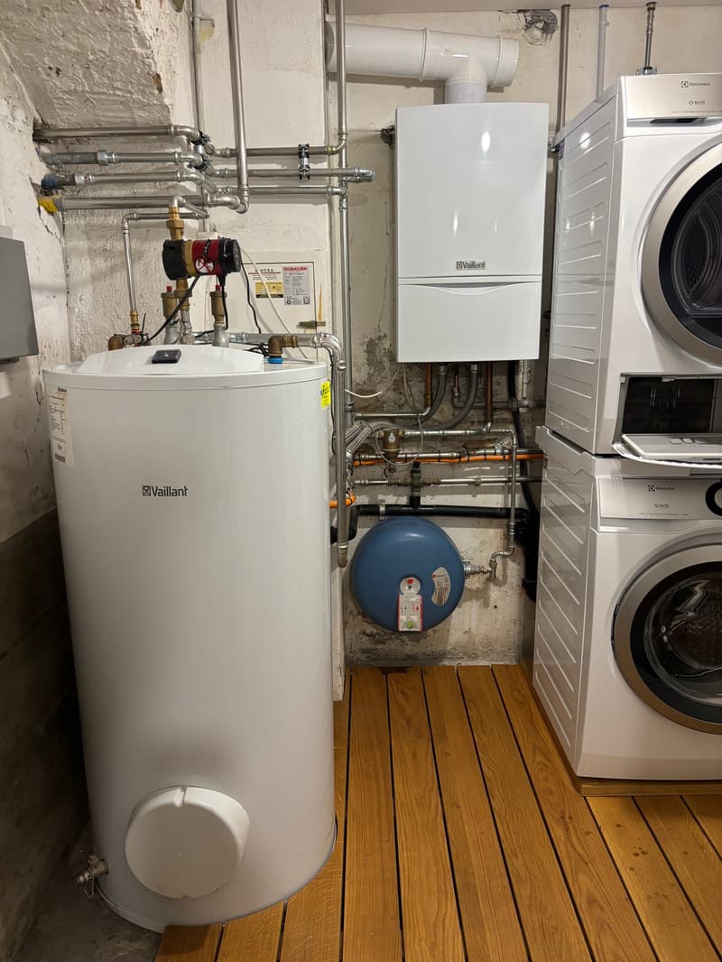 boiler, washing machine, blue tank, wooden floor, pipes, heater
