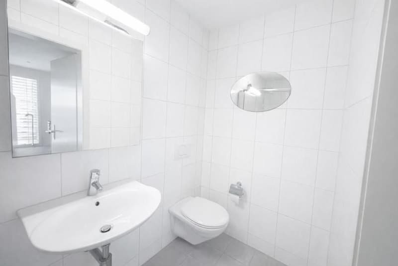 modern bathroom, white tiles, sink, mirror, toilet, round mirror, tiled floor