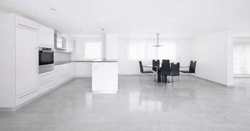minimalist kitchen with white tiles, cabinets and countertops, black table and chairs, modern lighting