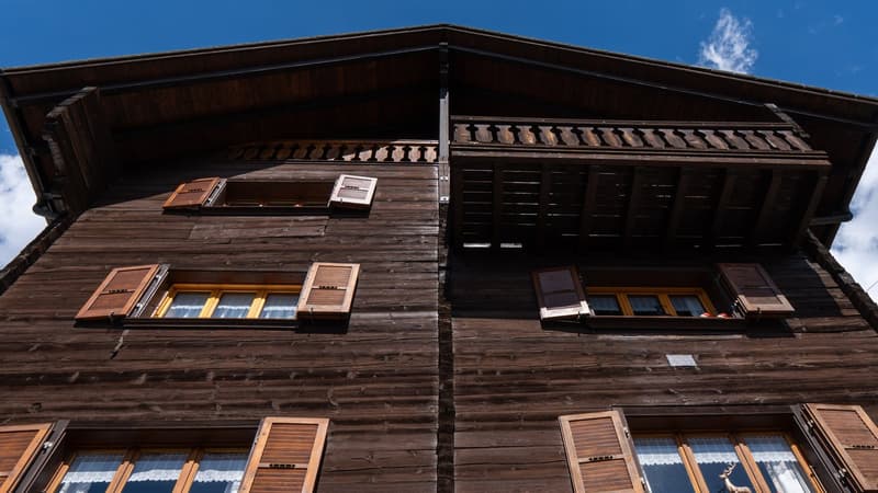 wooden exterior, multiple windows, balcony, yellow window frames