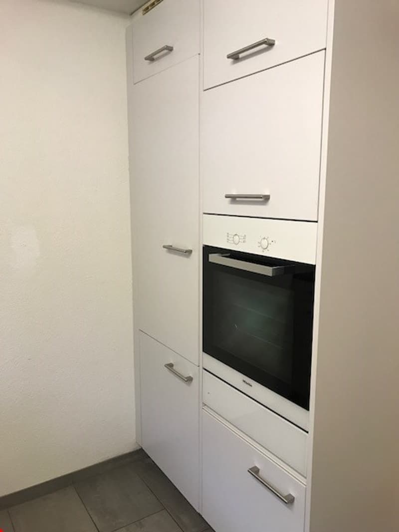 White cabinets, built-in oven, dishwasher