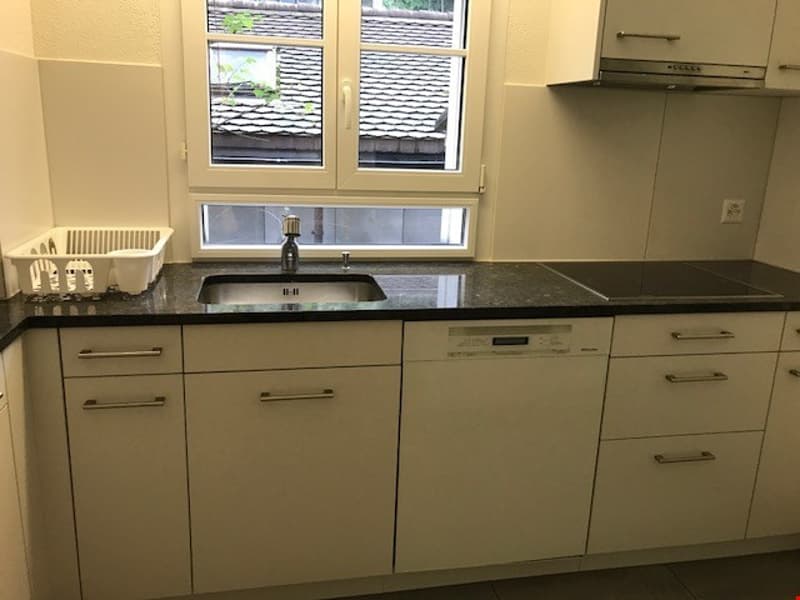 kitchen with dishwasher, granite countertop, cabinets, sink with faucet, window