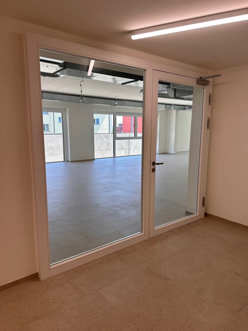Empty room, white walls, glass sliding doors, beige tiled floor, recessed ceiling lighting