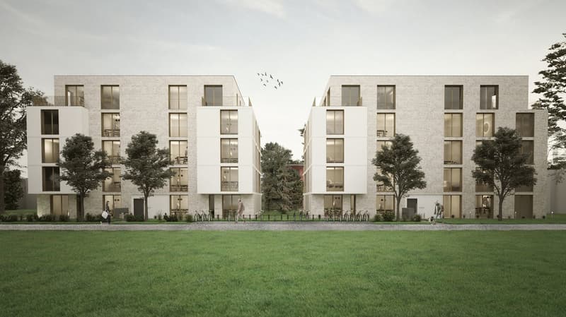 A modern multi-story apartment building with a uniform facade made of light-colored bricks. The building has multiple balconies and large windows. There is a grassy lawn in the foreground with some people walking around.
