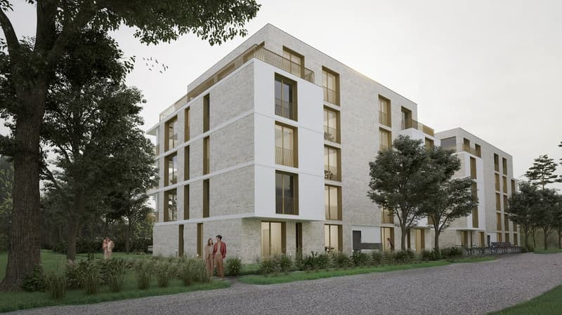 A modern, multi-story apartment building with a clean, minimalist design. The building features a white facade with large windows and balconies on each floor. The building is surrounded by trees and greenery, creating a pleasant outdoor environment.