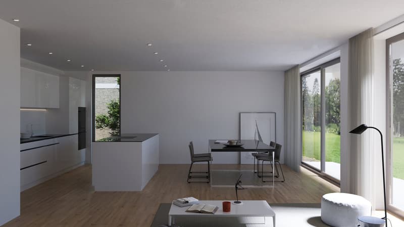 The image shows a modern, open-plan living room and kitchen area with large windows overlooking a green outdoor space. The room has a minimalist, gray color scheme with hardwood floors. The kitchen features sleek, white cabinets and countertops, while the
