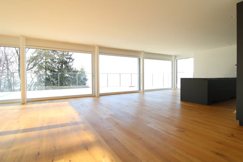 large windows, balcony, hardwood floors, modern design, view of trees