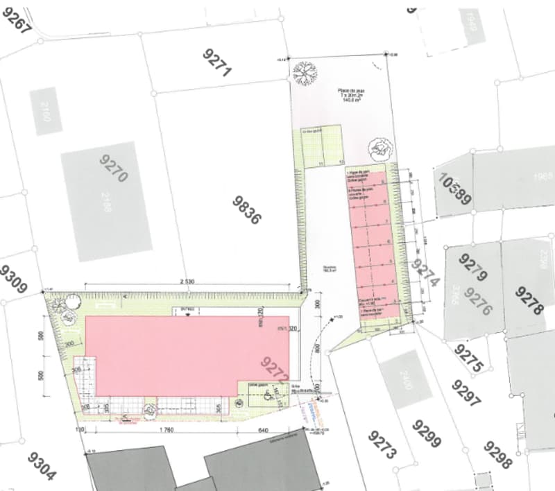 The image shows a floor plan or site plan. It includes a large rectangular plot of land, with a smaller rectangular building or structure in the center. There are additional smaller plots or parcels of land adjacent to the main plot. The visible features
