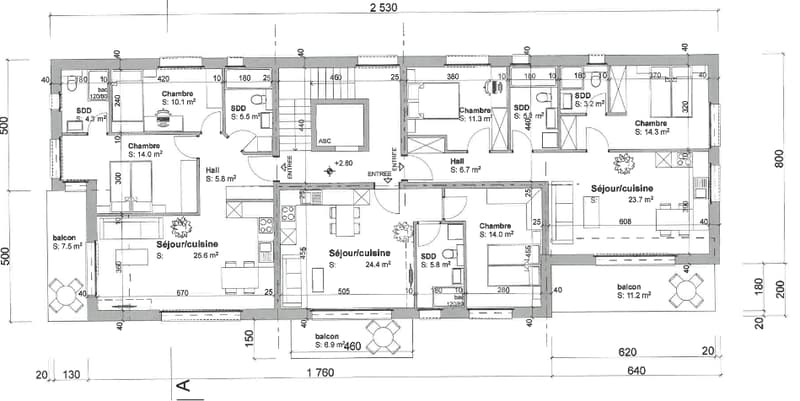 The image shows a floor plan of a residential building. It consists of multiple rooms, including bedrooms, living rooms, kitchens, and bathrooms. The plan also includes balconies and terraces.