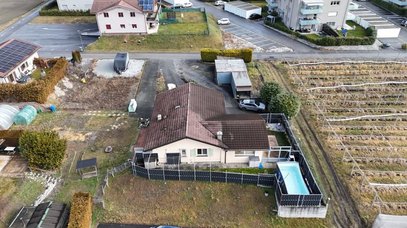 detached house, brown roof, beige wall, driveway, pool, solar panels, fenced garden