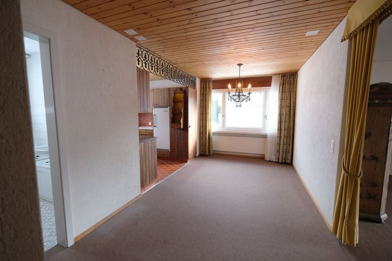 large empty room, wooden ceiling, chandelier, open doorway, tiled flooring, wooden cupboards, window, curtains
