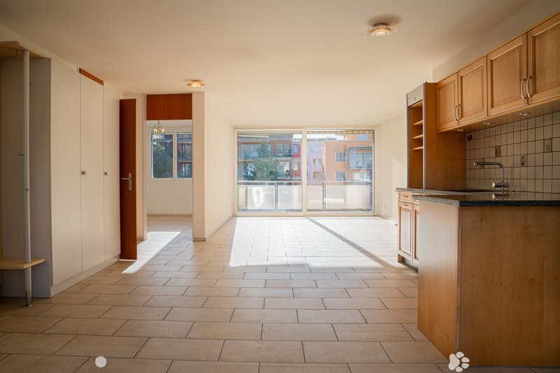 Open floor plan, tile flooring, modern cabinets, skylights, glass doors to balcony