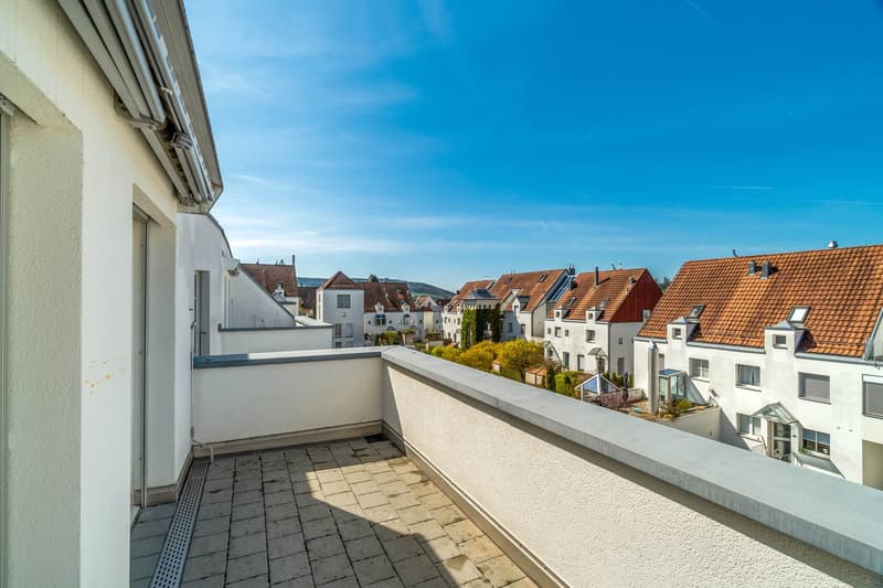 Balcony with tiled floor, white walls, and a view of the neighborhood