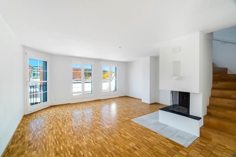 empty room, wooden floor, white walls, fireplace, large windows, stairs