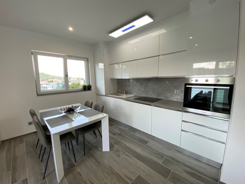 modern kitchen, white cabinets, granite countertops, stainless steel appliances, large window with view